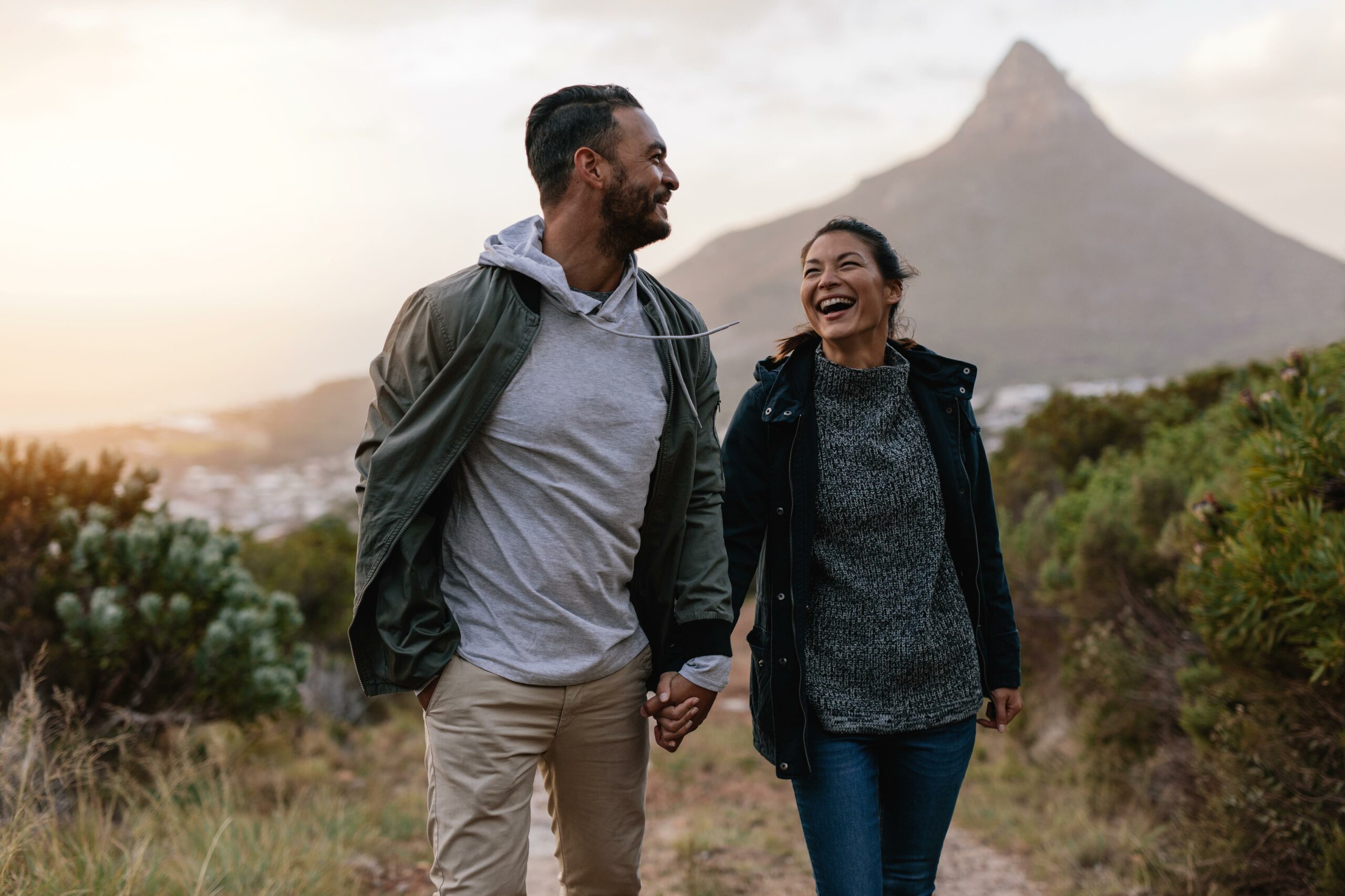 Young couple laughing and walking outdoors